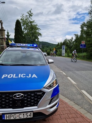 Radiowóz i jadący kolarz