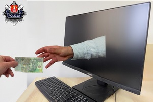 dłoń podająca polski pieniądz do  ekrany komputera  z którego wychodzi ręka