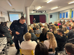 dzielnicowy przekazuje elementy z walizki rodzicom