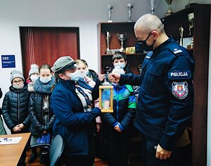 zastępca Komendanta odbiera od harcerki światełko