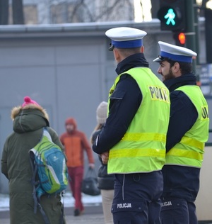 dwóch umundurowanych policjantów ruchu drogowego stojących przy przejściu dla pieszych